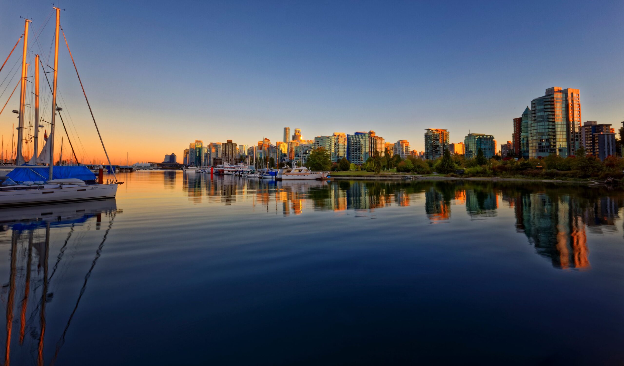 A photo of the city skyline view from Granville Island at sunset. 